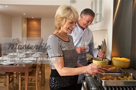 Couple Preparing Food For A Dinner Party