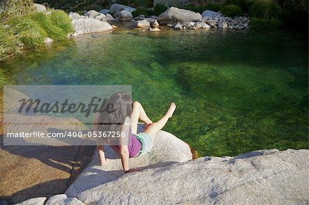 woman on a river at Gredos mountains in Avila Spain