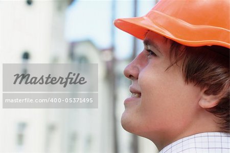Close-up portrait of a smiling young worker outdoors