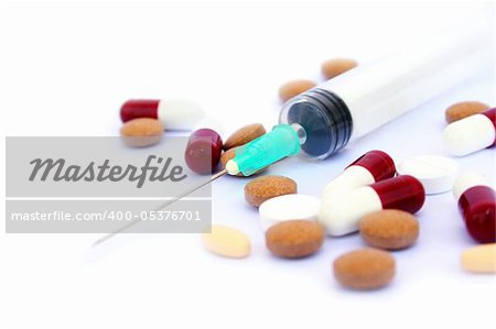 Medical pills, tablets and syringe isolated on white background.