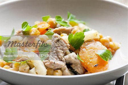 pork meat on celery with carrot and chick peas