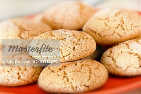 heap of fresh appetizing oatmeal cookies on red plate