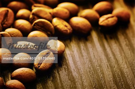 Coffee beans background macro shot on wooden background with copyspace