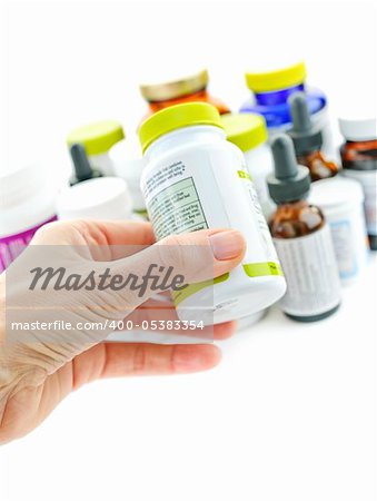 Hand holding medicine bottle to read label