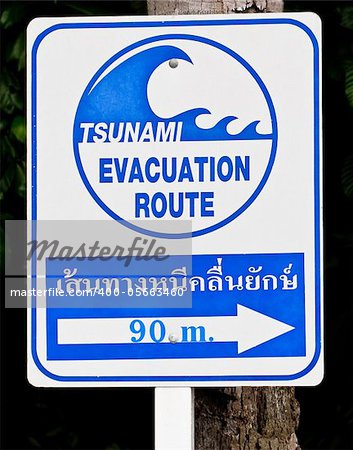 A tsunami warning sign located near a beach in Phuket, Thailand