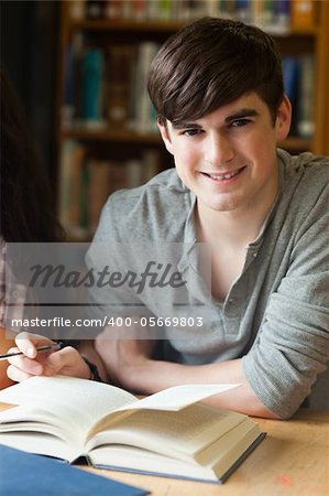 Portrait of a smiling student in a library