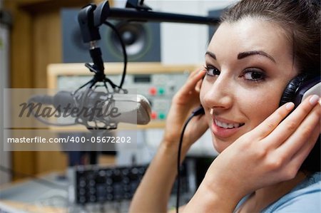 Close up of a young radio host posing in a station