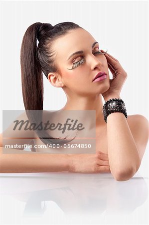 portrait of pretty and sensual brunette with hair pony  tail and creative make up with long eyelashes posing