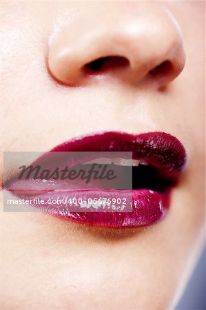 Girl's lips with dark red lipstick closeup