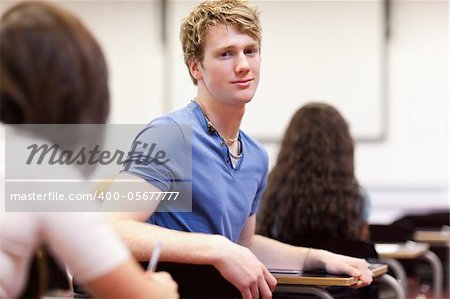 Student sitting at a table in a classroom