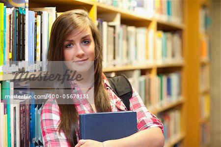 Calm female student posing in a library