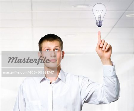 businessman pressing a touchscreen button on a office background