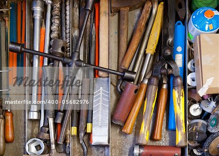 many different hand tools in drawer. mechanical and garden tools