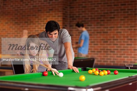 Couple playing snooker in a student home