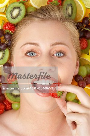 Portrait Of Young Woman Eating Strawberry