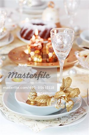 Place setting for Christmas in golden and white tone