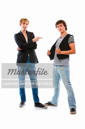 Teenager pointing on his friend. Isolated on white