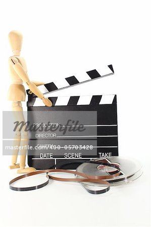 clapperboard with screen roll and wooden doll on a white background