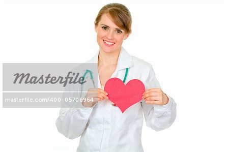Smiling medical doctor woman holding paper heart isolated on white