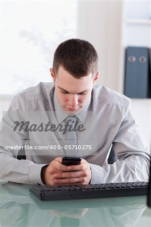 Close up of businessman reading text message carefully