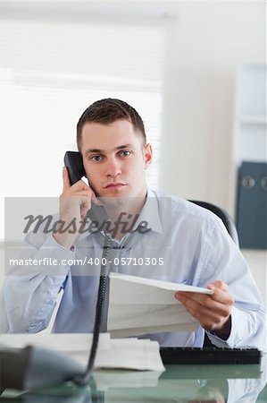 Close up of young businessman calling the author of a letter