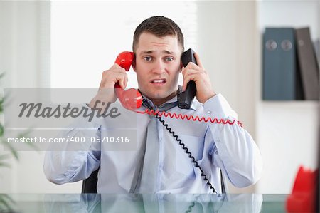 Stressed businessman unable to cope the telephone