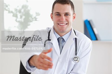 Smiling doctor welcoming patient