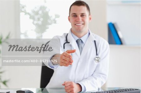 Smiling young doctor welcoming patient