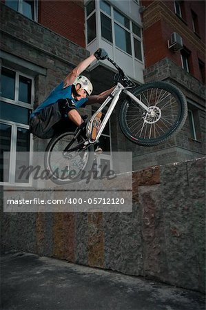 Biker standing on border after hard jump