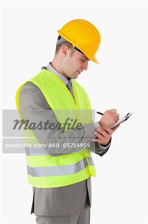 Portrait of a builder taking notes against a white background