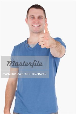 Portrait of a smiling man with the thumb up against a white background