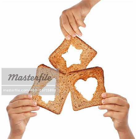 Kids hands holding bread with christmas symbols - love and sharing concept