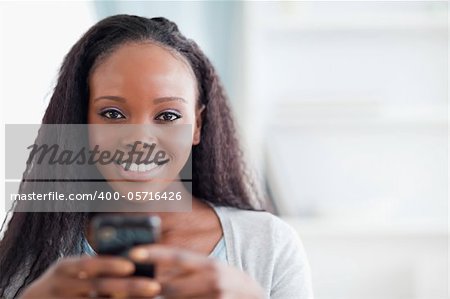 Close up of smiling woman holding cellphone