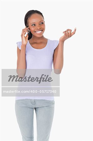 Close up of smiling woman talking on the phone on white background