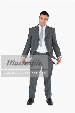 Businessman with empty pockets against a white background