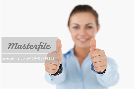 Young businesswoman giving approval against a white background