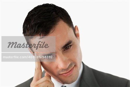 Close up of thinking businessman rubbing his temple against a white background