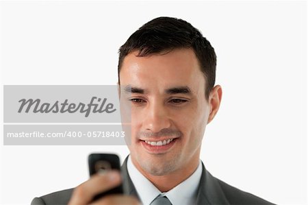 Close up of businessman reading a text message against a white background