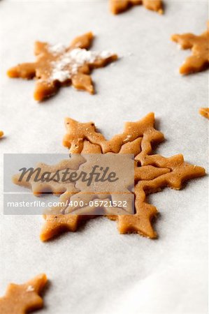 Making gingerbread cookies for Christmas. Gingerbread dough with star shapes.