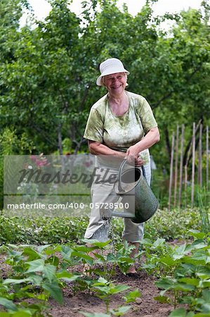 Happy senior woman working in her garden