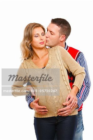 Young husband kissing his pregnant wife  on white background