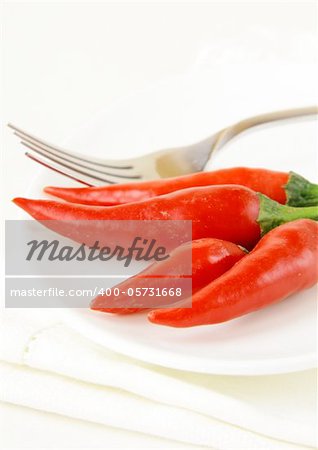 hot chili peppers on white plate