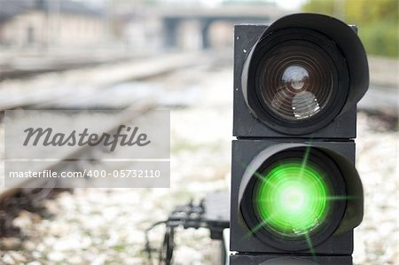 Traffic light shows red signal on railway. Green light