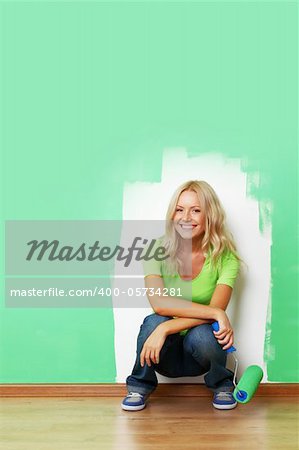 woman paints the wall brush isolated