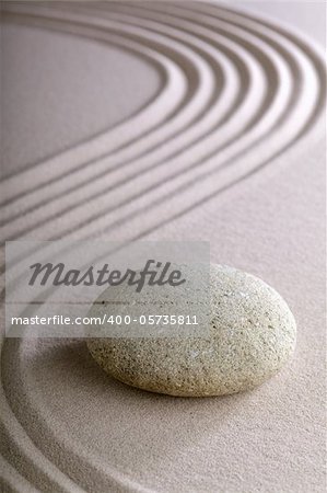 Japanese meditation or zen garden simplicity , calmness and balance in a pattern of lines in sand and round stones