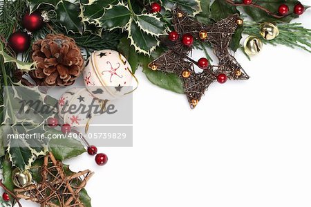 Christmas border with jingle bells, stars and other Christmas ornaments and decorations isolated on white. Shallow dof