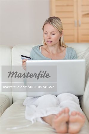 Young woman entering her credit card information