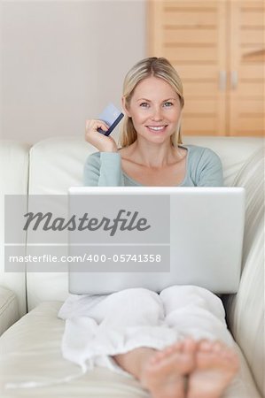 Smiling young woman shopping online