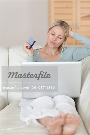 Young woman on the sofa shopping online