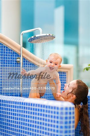 Mom playing with baby while taking shower